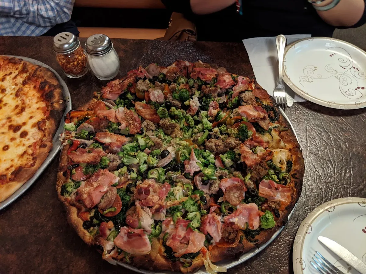 Two pizzas on the table at Ernie's Pizza & Restaurant
